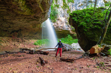 A woman in Waterfall Caucasus, mainsail cave