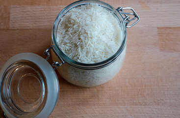 Rice in a bowl on wooden table background