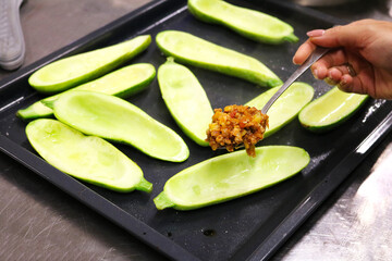 Halves of green zucchini on the back. Spoon with minced meat.