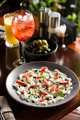 Gourmet Stracciatella cheese with strawberry, balsamic, mint salad with strawberry lemonade on the table at restaurant