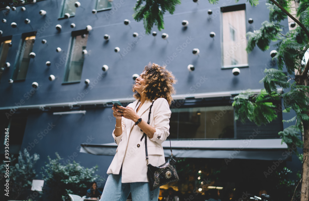 Aufkleber happy travel blogger rejoicing at touristic street using cellular device for roaming networking duri