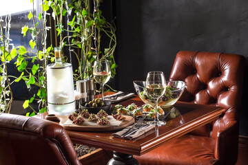 Gourmet meals assorted set appetizer with glass of white wine on the table at restaurant