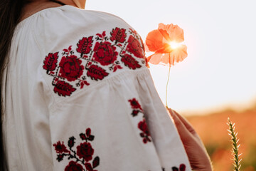 Girl in Ethnic Needlework Shirt Hold Poppy Flower