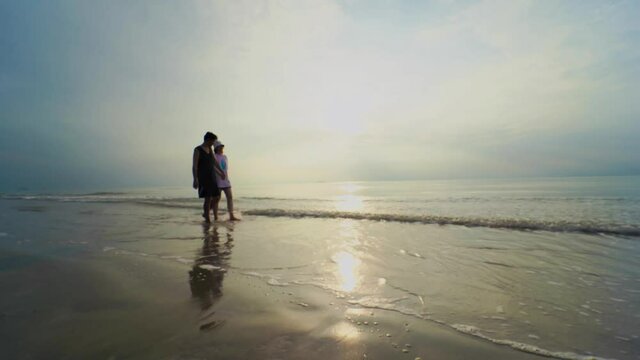 4K VDO silhouette asian couple hug and holding hand with happiness and joyful from honeymoon activity in summer