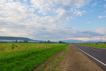 Fototapeta na wymiar Field and road. Sunrise landscape, summer