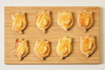 Tasty homemade Christmas cookies, freshly baked Cashew nut biscuits in the shape of a doll on white table