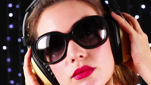 Girl wearing sunglasses and headphones