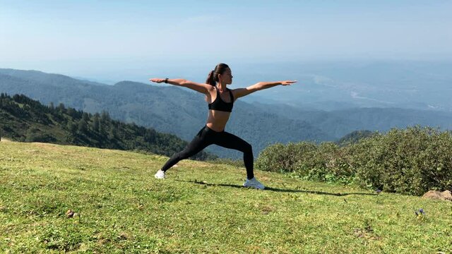 Woman Practicing Yoga on a Mountains. Girl Doing Exercise Alone in Nature