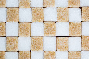 Brown or cane and white sugar cubes as background or texture, food concept