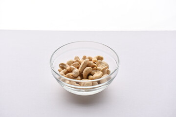 Superfood, vegan ingredients photographed on a high-key background, include bananas, blueberries, kale, soy milk, flaxseed milk, peanut butter, pumpkin seeds and salt.