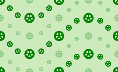 Fototapeta na wymiar Seamless pattern of large and small green car wheel symbols. The elements are arranged in a wavy. Vector illustration on light green background
