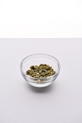 Superfood, vegan ingredients photographed on a high-key background, include bananas, blueberries, kale, soy milk, flaxseed milk, peanut butter, pumpkin seeds and salt.