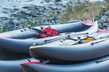 Inflatable boats on the mountain river shore.