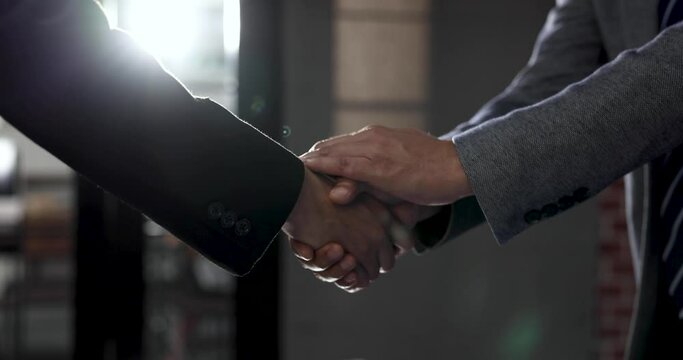 Business people shake hands when reaching a business agreement together.