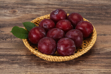 Plum heap in the wooden basket