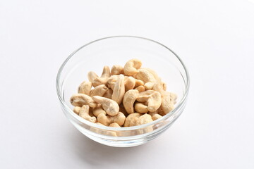 Superfood, vegan ingredients photographed on a high-key background, include bananas, blueberries, kale, soy milk, flaxseed milk, peanut butter, pumpkin seeds and salt.