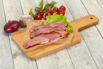 Sliced smoked duck breast served salad