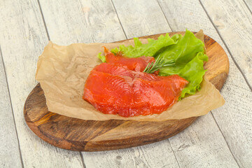 Sliced salmon fillet served rosemary