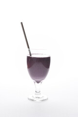 Vegan blueberry smoothie, with cashews, kale, maple syrup, bananas, pumpkin seeds and peanut butter, with a metal straw.