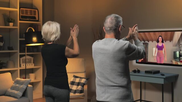 old couple exercising workout at home class course online,elderly people healthy lifestyle does exercise training at home watching an internet lesson live streamed from their personal trainer