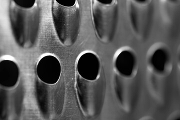 Vegetable slicer, grater abstract close up macro shot for background, in black and white.