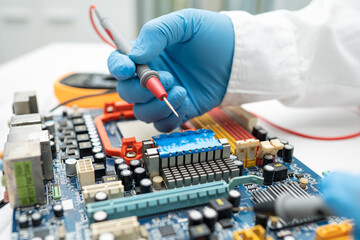 technician repairing inside of hard disk by soldering iron. Integrated Circuit. the concept of...