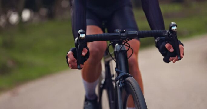 Male cyclist riding professional bicycle with black handlebars