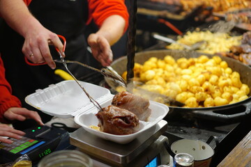 Food booth selling traditional Polish street food at a Christmas Market stall in Krakow, Poland. Traditional Polish street food in Cracow.      
