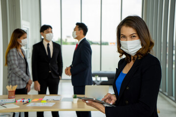 Fototapeta premium Asian executive businesspeople meeting in new normal office