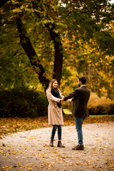 Young couple having fun in the autumn park