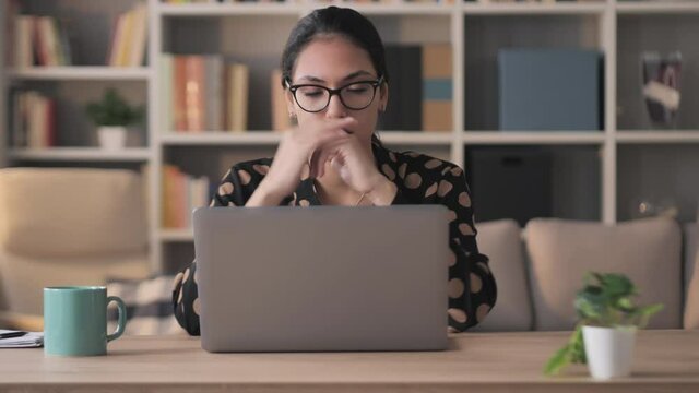 mixed race frustrated exhausted businesswoman works at computer from home,young middle eastern woman entrepreneur upset stressed typing at the laptop reading bad news on social media