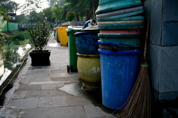 Row of garbage bins lined up along the park