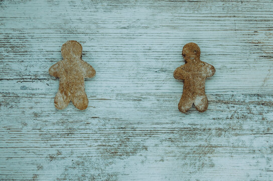 Socially Distancing Gingerbread People On A Wooden Table 