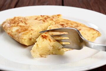 Eating Spanish omelette. Macro.