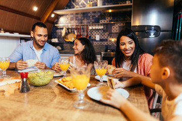 Latin family having dinner at home