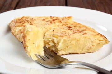 Eating Spanish omelette. Macro.