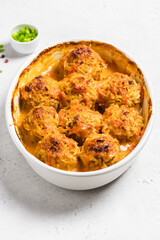 Homemade turkey zucchini meatballs in a baking dish. Space for text.