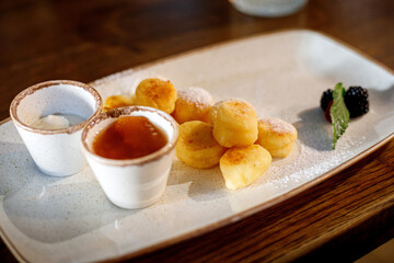 Cheese pancakes on a plate with jam