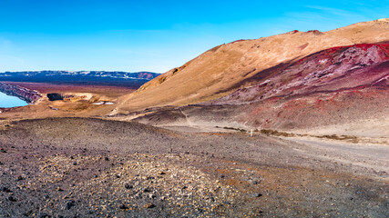 Fototapeta na wymiar Panoramic view over Icelandic landscape of colorful volcanic caldera Askja, Viti crater lake in the middle of volcanic desert in Highlands, with red, turquoise volcano soil and hiking trail, Iceland