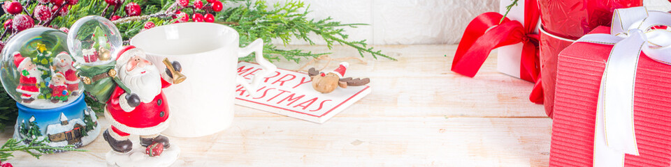 Christmas greeting cad background with decor, baubles, Xmas Gift Boxes, snow globe, hot chocolate...