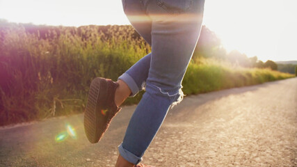 Girl is dancing on a sidewalk