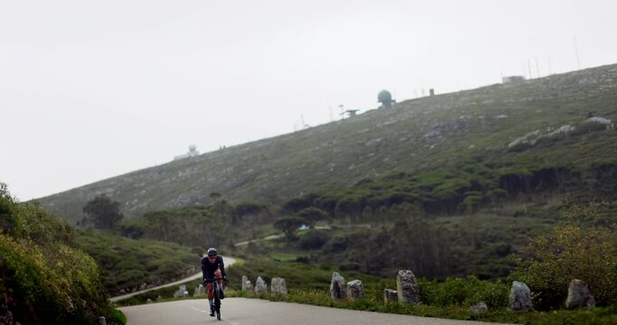 Professional cyclist going fast uphill a mountain