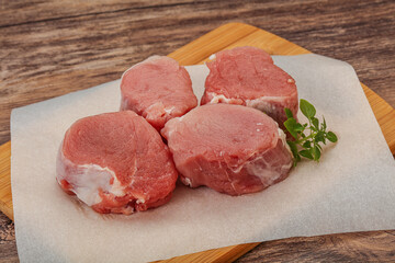 Raw pork medallion served rosemary