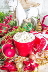 Christmas greeting cad background with decor, baubles, Xmas Gift Boxes, snow globe, hot chocolate cup. White wooden Cozy Festive Winter Christmas Background. Xmas or New Year Composition.