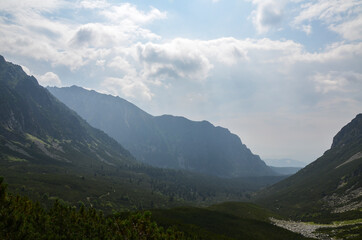 Foggy mountains landscape, hiking trail in Mengusovska valley, High Tatras (Vysoke Tatry), Slovakia