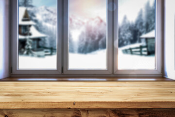 Wooden table by the window in a warm interior