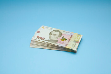 Obraz na płótnie Canvas Ukrainian currency on a blue background. A pile of money. Hryvnia