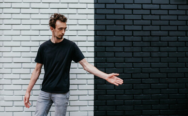 Young charismatic hipster guy wearing black blank t-shirt. Mock-up for print. T-shirt template.