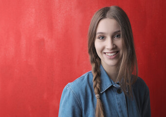 portrait of young woman on a red background