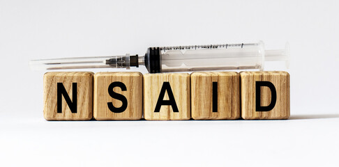 Text NSAID made from wooden cubes. White background